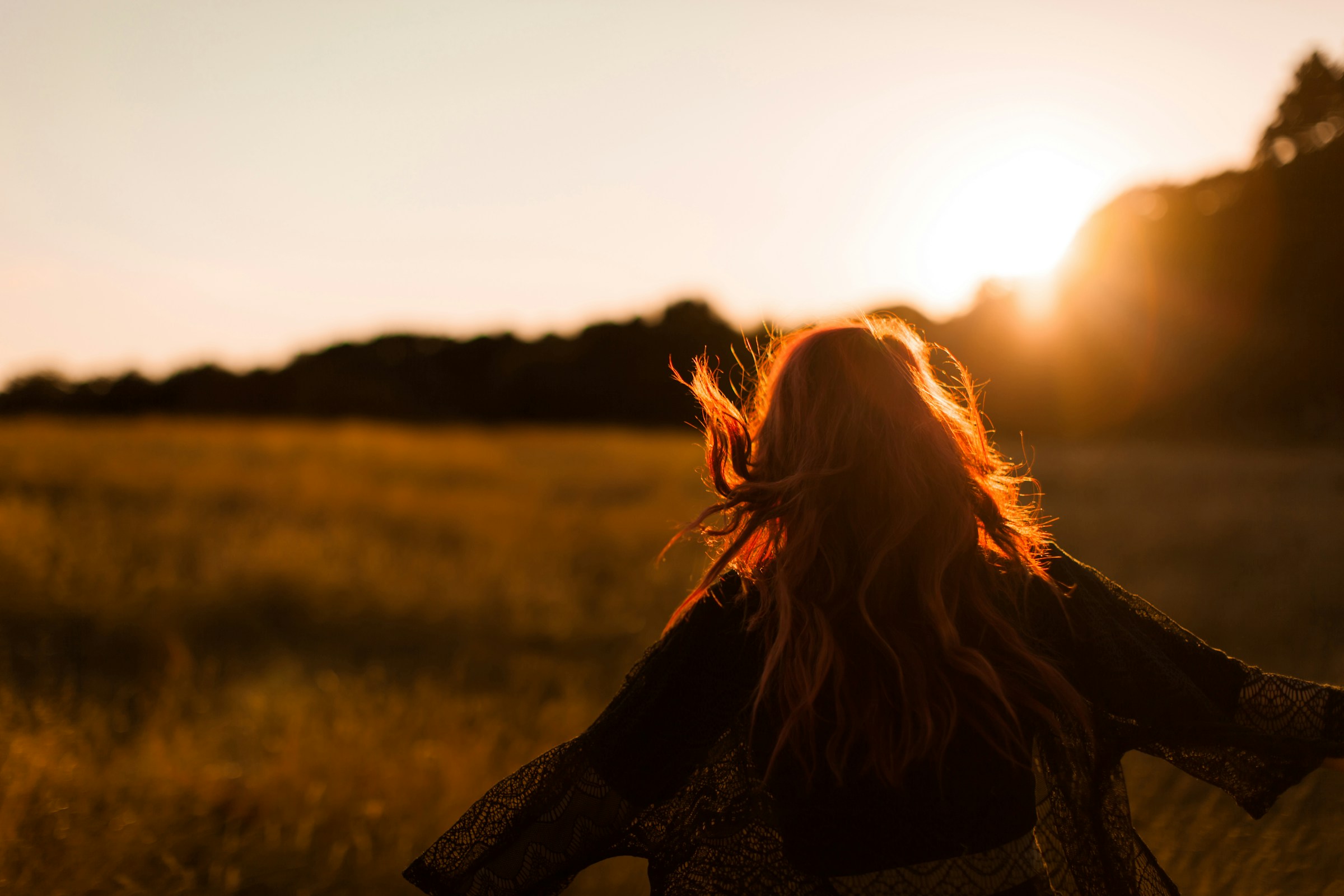 Person walking in a sunrise